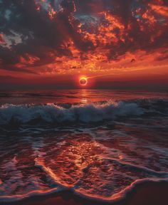 the sun is setting over the ocean with waves crashing in front of it and an orange sky