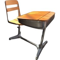 an old school desk with a wooden seat and metal frame on the legs, against a white background