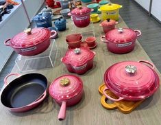 many pots and pans are lined up on the table