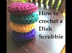 a stack of crochet dish scrubbies sitting on top of a wooden table