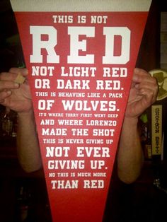 a man holding up a red flag with words on it that read, not light red or dark red