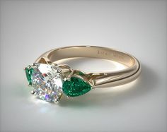 This 18k yellow gold three stone pear shaped emerald engagement ring is available exclusively from JamesAllen.com Diamond Rings With Emeralds, Engagement Rings With Emeralds Side Stones, Diamond Ring With Colored Side Stones, Engagement Ring With Emerald Side Stones, Round Diamond With Emerald Side Stones, Wedding Ring With Emerald Accents, Diamond And Emerald Engagement Rings, Diamond Engagement Ring With Emerald Accents, Emerald Accent Engagement Ring