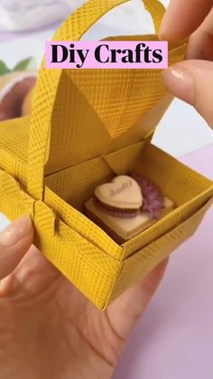 someone is holding an origami box with some food in it and the words diy crafts above it