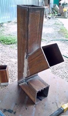 an open wooden box sitting on top of a table next to tools and other items