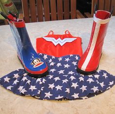 a pair of red, white and blue rain boots sitting on top of a table