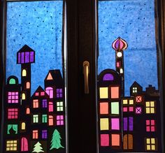 two stained glass windows with buildings and trees on them