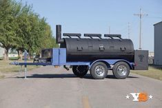 a blue and black trailer with a large tank on the back