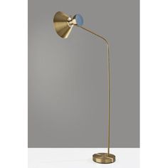 a gold floor lamp with a blue light on it