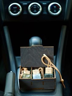 the inside of a car with an electronic device in it's storage compartment,