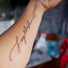 a woman's arm with a tattoo that reads, we are family