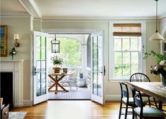 an open door leading to a dining room with chairs and table in front of it