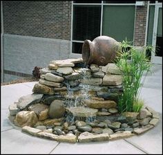 there is a water fountain made out of rocks