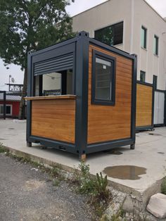 a small building made out of shipping containers