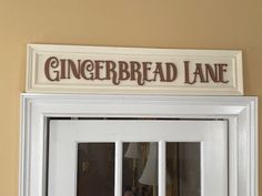 there is a sign that says gingerbread lane on the wall above an open door