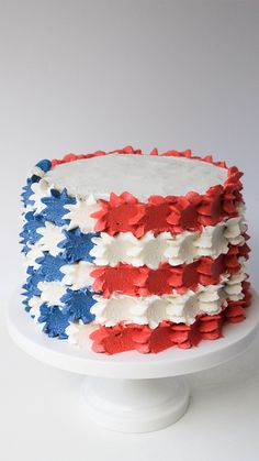 an american flag cake with white frosting and red, white, and blue icing