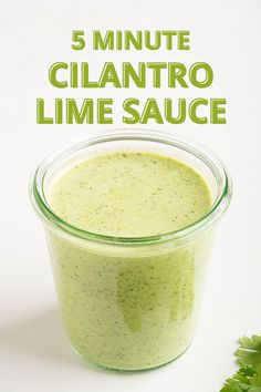 the 5 minute cilantro lime sauce is in a small glass container with parsley on the side