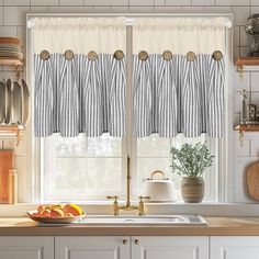 a kitchen with a sink, window and countertop covered in striped valances