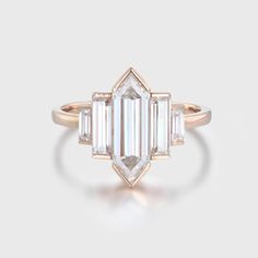 an emerald cut diamond ring with three baguets