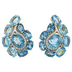 The retro ornamental design of paisley is given an elegant rendition in these earrings. Aquamarine in oval shapes outline the curved teardrop pattern, with a larger oval of the gem in the center. In between these two gems are brilliant cut diamonds in a curved teardrop shape to further accentuate the motif. 18k yellow gold both sets the gems and with clip-backs secures the earrings, which measure 0.84 inches (width) by 1.19 inches (length) by 0.30 inches (depth). Teardrop Pattern, Paisley Earrings, Cocktail Earrings, Aquamarine Earrings, Yellow Gold Earrings, Aquamarine Jewelry, White Gold Earrings, Antique Earrings, Yellow Gold Earring