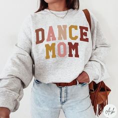 Cozy Dance Mama Sweatshirt, Dance Mom Shirt, Mom of Dancer, Dancing Mom Shirt, Dance Mama Sweater, Dance Mother Gift, Mother of Dancer Gift ✧ SIZING ✧ ⋒ Please check our size chart before placing an order. ⋒ If you want an oversized look, pick a sweatshirt that is 2 sizes larger than your usual size. ✧ IMPORTANT NOTE: We try to depict all shirt and design colors as close to the original as possible but depending on your screen settings or the shirt color you chose, the colors of the graphics may Dance Mom Sweatshirt, Long Sleeve Cotton T-shirt For Dance Class, Cotton Graphic Print Sweatshirt For Dance, Long Sleeve Cotton T-shirt For Dance, Cotton Tops For Dance Class In Fall, Long Sleeve Cotton Tops For Dance Class, Fall Dance Cotton Sweatshirt, Cotton Sweatshirt For Dance In Fall, Cotton Long Sleeve Sweatshirt For Dance Class