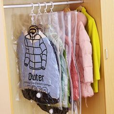 the coat rack is filled with coats and other items in plastic bags on hangers