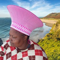 Plain pink and white ZULU HAT is called ISICHOLO in traditional Zulu language and is traditionally worn during religious and cultural ceremonies. by the married Zulu woman of South Africa   The form of the isicholo, or married woman's hat, developed out of a 19th-century conical hairstyle that was worn as a sign of respect to one's husband and his family, in addition to serving as a public symbol of married status. In the early 20th century, a removable hat like this one replaced the hairstyle. Traditional White Festival Hat, White Traditional Festival Hat, Traditional White Hat For Festival, Traditional White Ceremonial Hat, Traditional White Wide Brim Hat, Traditional White Cap, White Ceremonial Cap, Zulu Language, Zulu Hat