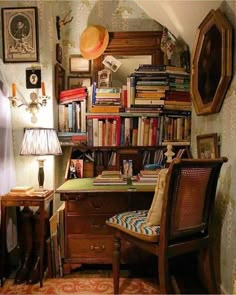 an old fashioned desk and chair in front of a bookshelf with many books on it