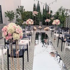 tables and chairs set up with flowers on them