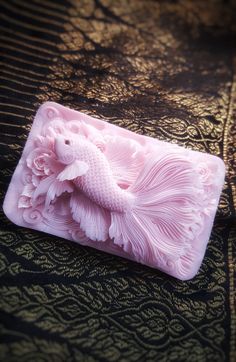 a pink soap mold sitting on top of a table