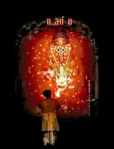 a man standing in front of a lit up gandap with lights on it