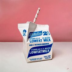 a carton of lowfatmilk with a toothbrush sticking out of it