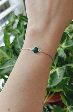 This minimalist style emerald bracelet is perfect for everyday wear. It's beautiful on its own, but also makes a great layering piece. Created with a silver plated natural emerald that is attached to a dainty rhodium plated chain with a slider bead that makes it adjustable. It is finished off with two ball ends. Emerald is the May birthstone. It is often associated with abundance and unity.  All jewelry comes ready to gift in a 100% recycled kraft paper box with eco-fiber filling and an elastic ribbon. Check out some of my other bracelets here https://www.etsy.com/shop/LivinFreely?section_id=14038074 Adjustable Dainty Green Chain Bracelet, Green Round Chain Bracelet Gift, Dainty Green Adjustable Chain Bracelet, Minimalist Adjustable Emerald Jewelry, Everyday Minimalist Emerald Jewelry, Minimalist Green Bracelet, Green Bracelet With Adjustable Chain, Green Chain Bracelet For May Birthstone Gift, Green Bracelets With Adjustable Chain