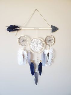 a white and blue dream catcher hanging on the wall