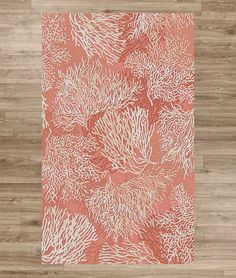 an orange and white rug with corals on it