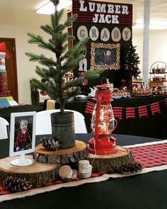 there is a small christmas tree in the center of this table with decorations on it