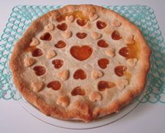 a heart shaped pizza on a plate with doily