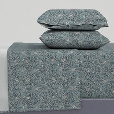 three pillows are stacked on top of each other