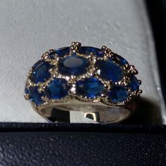 Elevate Your Jewelry Game With This Stunning Royal Blue Cz Cluster Statement Dome Ring In Silver-Plated Finish. Perfect For Occasions Like Engagement, Mother's Day, Christmas, Graduation, Wedding, Anniversary, Father's Day, Birthday, And Valentine's Day, This Ring Is Sure To Make A Statement. The Ring Features An Oval Shape And A Pav Setting Style With Stackable Features, Making It A Versatile Addition To Your Collection. The Ring Is Available In Sizes 11 And 12 . The Main Stone Is Made Of Cubic Blue Formal Jewelry With Stones, Formal Blue Jewelry With Stones, Formal Blue Stone Jewelry, Fine Jewelry Blue Sapphire Ring With Vs Clarity, Blue Ring Jewelry For Party, Blue Sapphire Ring For Party, Blue Party Ring Jewelry, Blue Oval Party Jewelry, Silver Sapphire Ring For Party