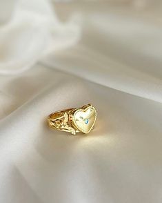 This Heart Locket Ring is crafted from gold plated silver for a luxurious feel and timeless look. Its elegant design is perfect for the special occasions that call for you to make a powerful, romantic statement. Wear it to express love, adoration, or devotion. Gold Plated Heart Ring For Gift, Gold-plated Promise Rings, Gold Crystal Promise Ring, Tarnish Resistant, Gold Crystal Ring For Promise, Tarnish Resistant, Elegant Heart Promise Ring, Gold Plated Round Heart Ring As Gift, Classic Crystal Ring As Gift, Heirloom Promise Ring Jewelry For Valentine's Day, Elegant Flower Open Ring For Valentine's Day