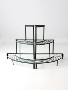 three tiered metal shelf sitting on top of each other