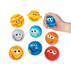 a hand is holding an assortment of smiley faces