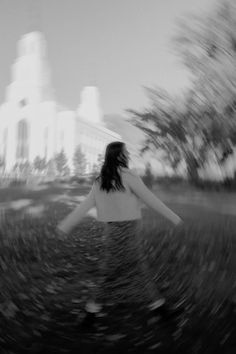 a blurry photo of a woman walking down a street