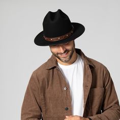 Features: Brim Size: 2.75" 100% wool Size: Men's s/m: 58cm, l/xl: 60cm Wool felt cowboy hat with embossed faux leather trim and studs Winter Leather Felt Hat For Western-themed Events, Brown Leather Fedora For Fall, Brown Leather Fedora For Winter, Leather Fedora For Fall, Western Style Fur Felt Fedora With Flat Bill, Adjustable Leather Hat For Fall, Adjustable Leather Fedora For Winter, Fitted Leather Fedora For Fall, Adjustable Leather Winter Fedora