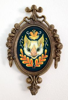 an ornate frame with a painting of a fox on it