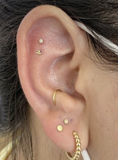 a close up of a person with ear piercings on their left and right ears