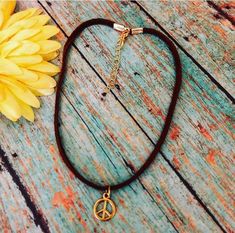 This tiny peace sign is on a 3MM dark brown suede the peace sign is gold plated 10 MM great piece for layering BoHo necklaces, I do add a 2 inch extension with each necklace Boho Necklaces, Boho Layering, Anklets Boho, Adjustable Brown Trendy Choker, Handmade Brown Hippie Choker, Trendy Adjustable Brown Choker, Adjustable Brown Hippie Choker, Stacked Beaded Bracelets, Peace Sign Necklace