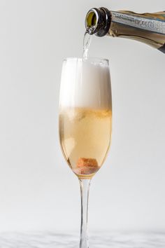 champagne being poured into a glass with the words classic champagne cocktail