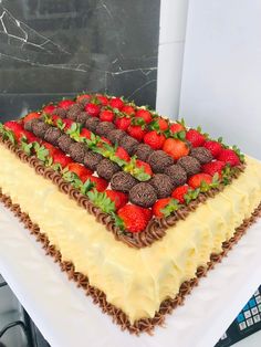 a cake with strawberries and chocolate on top