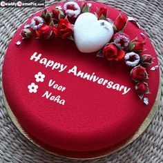 a red cake with white frosting and flowers on it that says happy anniversary afka bava