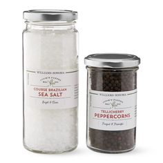 two jars with sea salt and peppercorin in them